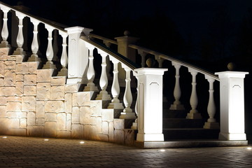 Columns of a white staircase at night