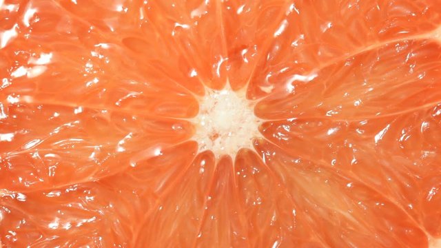 Close up of Grapefruit with falling water drops. No sound.