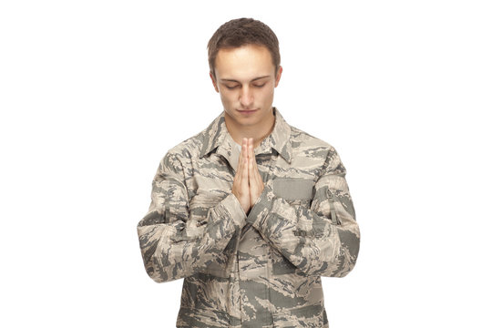 Air force airman with hands clasped for prayer