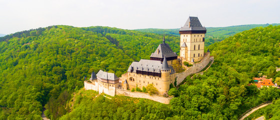 Aerial view to The Karlstejn castle. Royal palace founded King Charles IV. Amazing gothic monument...