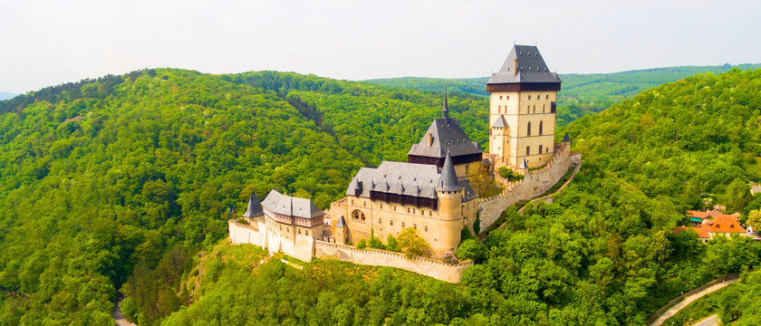 Aerial view to The Karlstejn castle. Royal palace founded King Charles IV. Amazing gothic monument in Czech Republic, Europe.