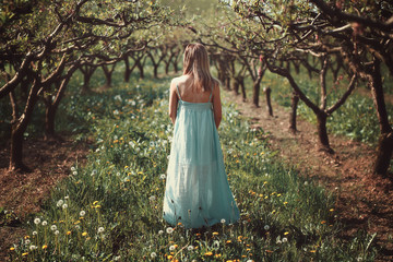Woman in an orchard with flowers