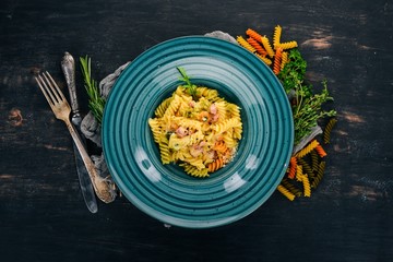 Carbonara Pasta with Bacon. On a wooden background. Italian cuisine. Top view. Copy space.