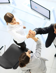 view from the top.members of the business team giving each other a high five above the Desk.