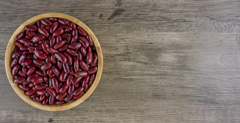 Obraz na płótnie Canvas Flat lay a cup of red beans on grey wooden background and copy space 
