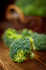 Beautiful broccoli crowns on wooden board.