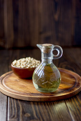 Natural soy bean oil with soybeans near it.