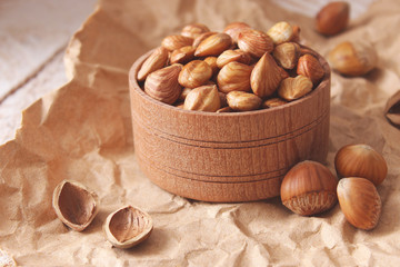 Peeled hazelnuts on the background of wood. useful snack, proper nutrition. how to peel the nuts.