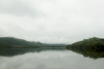 Landscape of Mountain on  Reservoir Tha Thung Na under cloudy on morning at Kanchanaburi Province of Thailand.