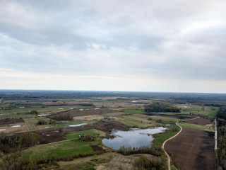 Fototapeta na wymiar drone image. aerial view of rural area with countryside lake enclosed by fields and forests
