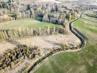 drone image. aerial view of rural area with wawy river ion forests