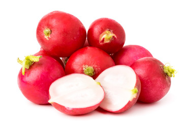 A bunch of radishes and halves on a white, closeup.