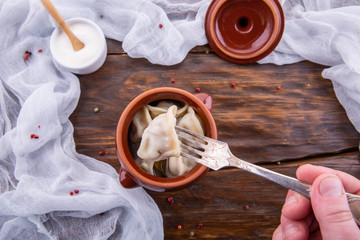 Meat meat and fresh sour cream dumplings, are served with spices in broth
