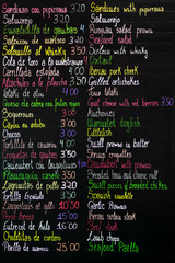 food menu in chalkboard in spanish and english languages