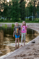 Girl and boy in the evening on the lake