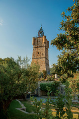 View of the clock tower made of stone on top of the hill with vegetation in the lively and gracious town of Draguignan. Located in the Var department, Provence region, southeastern France