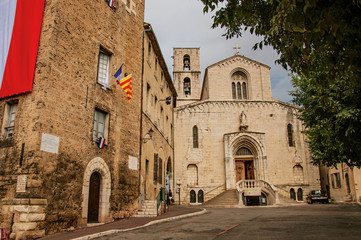 Street view with old church and building in the city center of Grasse, known for producing perfumes. Located in the Alpes-Maritimes department, Provence region, southeastern France