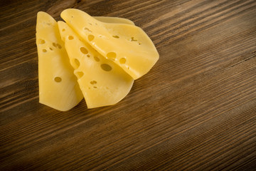 Sliced Cheese Over Rustic Wooden Background