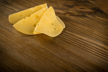 Sliced Cheese Over Rustic Wooden Background