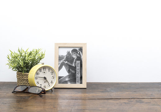 Framed Photo on Wooden Desk Mockup