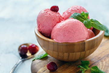 Natural cranberry ice cream in a wooden bowl.