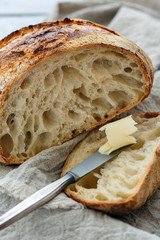Cut a loaf of artisanal bread on sourdough.