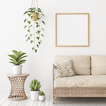 Home interior poster mock up with square empty wooden frame, wicker rattan sofa and plants in living room with white wall. 3D rendering.