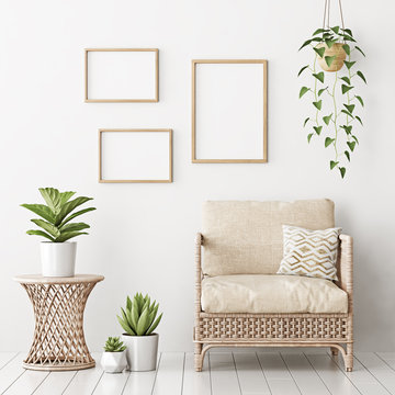 Home interior poster mock up with three empty wooden frames, wicker rattan armchair and plants in living room with white wall. 3D rendering.