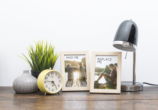 2 Framed Photos on Wooden Desk with Accessories Mockup