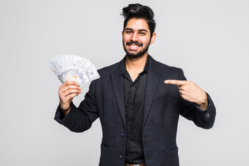 Closeup portrait of super happy excited successful young man holding money dollar bills in hand,...