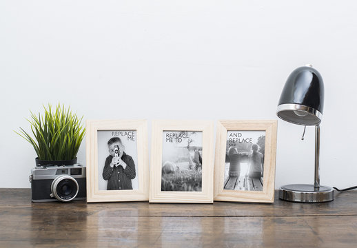3 Framed Photos on Wooden Desk with Accessories Mockup