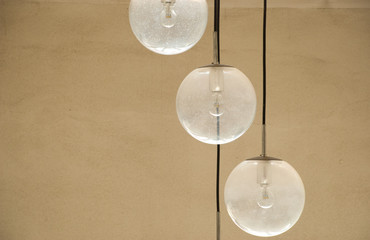 Illumination with three glass lamps balls. Electricity background.Abstract poster.