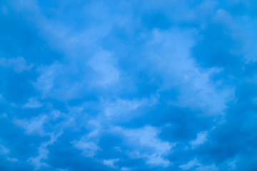 Fototapeta na wymiar Cloudy blue twilight sky close-up. Overcast weather. Dramatic background from many rainy clouds.