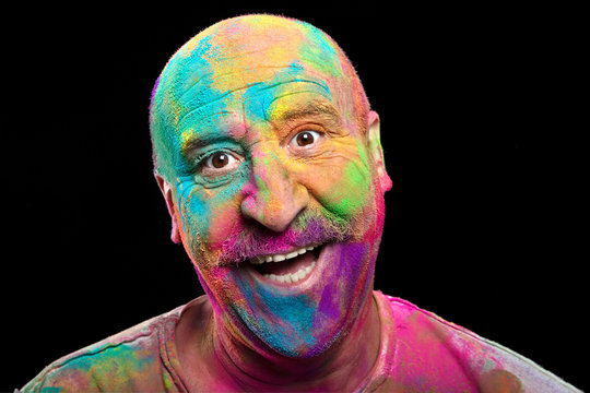 Happy man covered in brightly colored Holi Powder