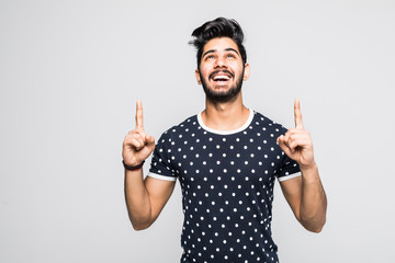 Indian man looking and pointing up his finger isolated on white
