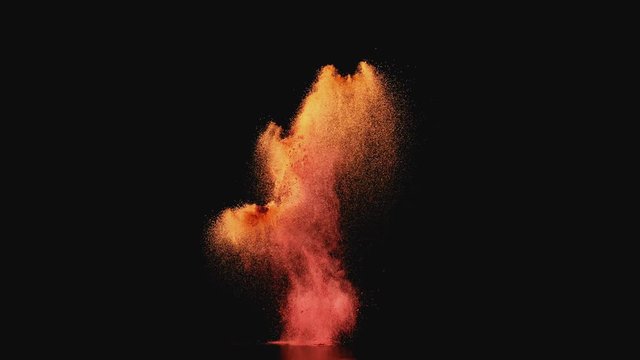 
Colored powder/particles fly against black background. Shot with high speed camera, phantom flex 4K. Slow Motion.