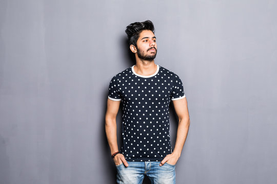 Portrait of a young indian man isolated on gray background