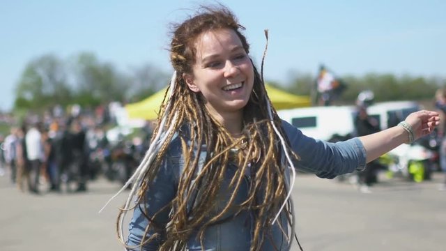 Young hipster woman with dreadlocks on street street