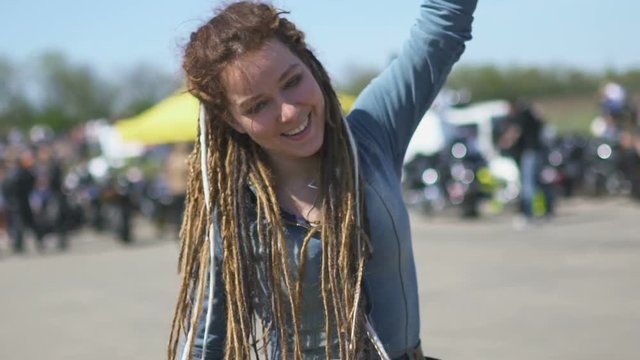 Young hipster woman with dreadlocks on street street
