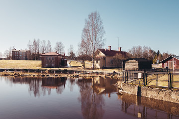 Finland Forssa, Loimijoki river at Kuhalankoski, a small boats marina at summer and with a dam on it's side. On a spring day when all snow has almost melted