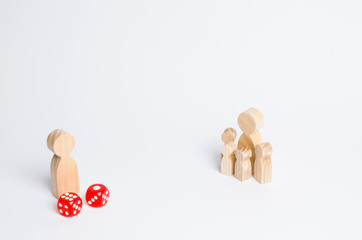 People are standing near dice. The family stands near the dice cubes. The concept of gambling, the dependence on gambling. Destruction of the family. Random, randomness.