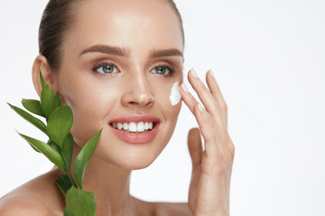 Beauty Face Care. Woman With Cream On Facial Skin