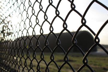 Fototapeta premium Close up shot of a chainlink fence on the border of Rendlesham Air Force base, UK