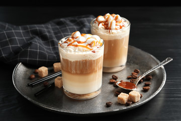 Glasses with delicious caramel frappe on tray