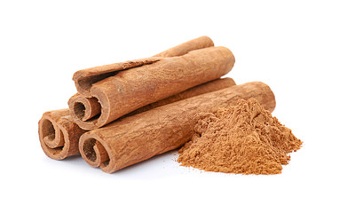 Aromatic cinnamon sticks and powder on white background