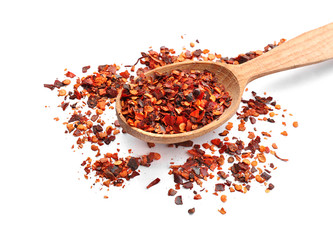 Wooden spoon and chili pepper flakes on white background