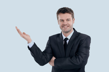 smiling businessman pointing copy space.