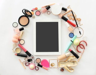 Fototapeta na wymiar Flat lay composition with makeup products for woman and tablet on light background