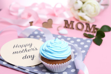 Festive surprise with tasty treat for Mother's Day on color background