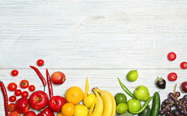 Rainbow composition with fresh vegetables and fruits on wooden background, flat lay